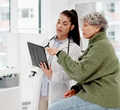 old woman or doctor shaking hands with patient