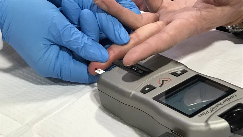 A point-of-care A1C and lipid blood test being performed on the expo floor by PTS Diagnostics. The test requires just a drop of blood and results can be shown in about 90 seconds. #ACC2022