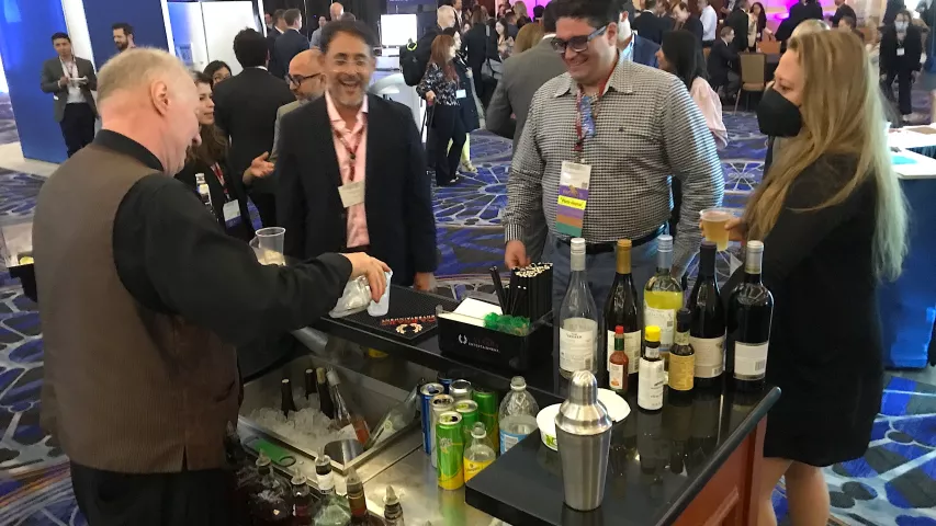 Attendees getting drinks on the expo floor during an evening reception during SCCT. Many attendees said they were glad to be back in person for networking, after two years of COVID required virtual meetings in 2020 and 2021. #SCCT #SCCT2022
