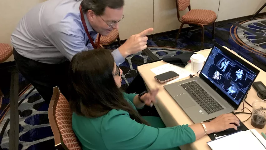 Kelley Branch, MD, MSc, FSCCT, associate director, clinical trials service unit, professor, of medicine, University of Washington Medical Center, helps an attendee learning how to evaluate cardiac CT congenital heart cases. The Congenital Disease Workshop as an all-day pre-conference course to sharpen reading skills for these difficult to interpret cases. #SCCT #SCCT2022 #yesCCT #cardiacCT