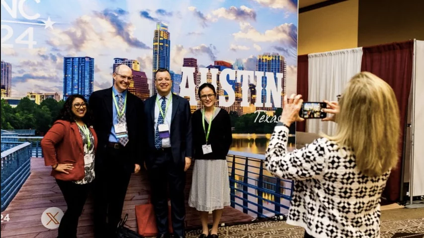 Attendees getting photos in front of the big ASNC 2024 Austin sign. Photo courtesy of ASNC