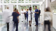 Hospital staff walking through a medical facility, intentionally blurred to look artistic