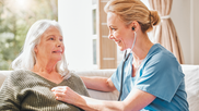 older patient with a doctor at their house