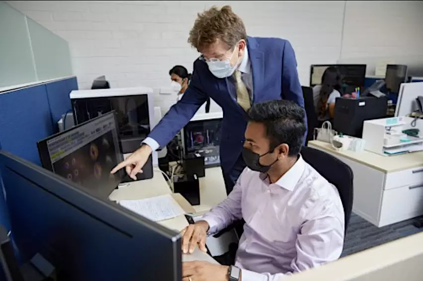 Piotr Slomka, PhD, standing, collaborates with Aakash Shanbhag, MS, a programmer and analyst in the Slomka Lab at Cedars-Sinai. The lab is working on several AI projects in cardiology and cardiac nuclear imaging.