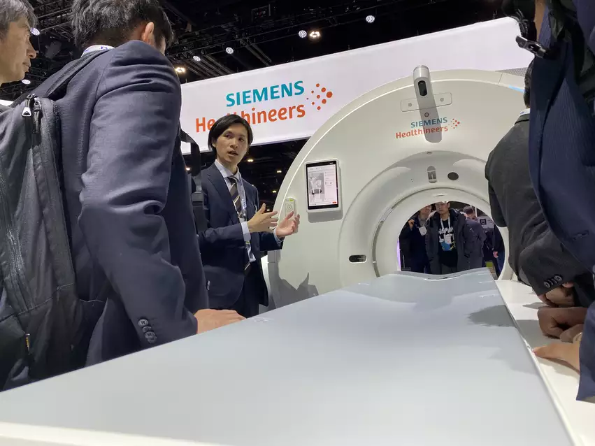 A crowd of attendees around the new Siemens Somatom Pro Pulse dual-energy CT system at RSNA 2023. While it is a general purpose scanner, Siemens is gearing marketing for this system toward the growing cardiac CT market. Photo by Dave Fornell