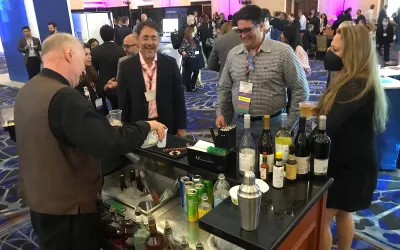 Attendees getting drinks on the expo floor during an evening reception during SCCT. Many attendees said they were glad to be back in person for networking, after two years of COVID required virtual meetings in 2020 and 2021. #SCCT #SCCT2022