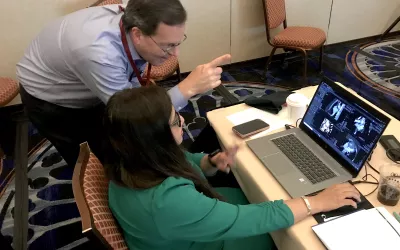 Kelley Branch, MD, MSc, FSCCT, associate director, clinical trials service unit, professor, of medicine, University of Washington Medical Center, helps an attendee learning how to evaluate cardiac CT congenital heart cases. The Congenital Disease Workshop as an all-day pre-conference course to sharpen reading skills for these difficult to interpret cases. #SCCT #SCCT2022 #yesCCT #cardiacCT