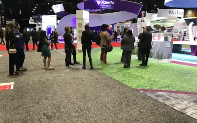 Attendees wait in a long line for frozen yogurt at one of the large pharma booths on the show floor at AHA22.