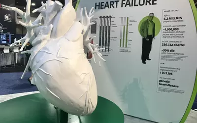 A giant heart and display on the science behind how to improve pumping function in heart failure patients in the Cytokinetics booth at ACC23.