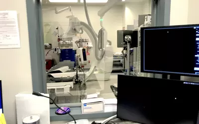 View of the cath lab from the control room for the cardiac cath lab at ambulatory surgical center (ASC) in Sun City, Arizona.