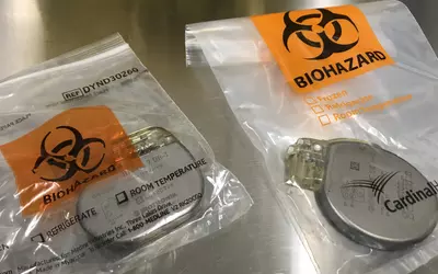 Explanted Biotronik implantable cardiovereter defibrillator (ICD) and Boston Scientific CRT-D devices packaged for return to the vendors, Banner Sun City ASC.