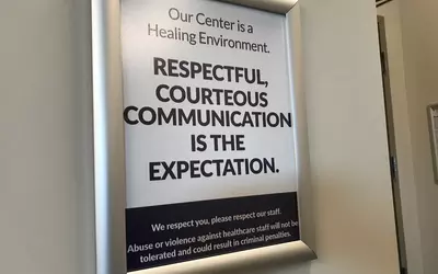A poster displayed in the reception area at the entrance into the Banner Sun City ASC asking patients to be respectful to the staff and clinicians. Banner ASC in Sun City, Arizona.