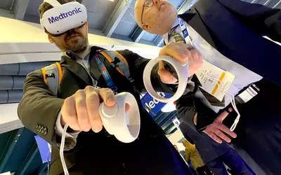 Virtual reality (VR) cath lab training demo in the Medtronic booth at TCT 2023. Cardiovascular Business Editor Michael Walter. Photo by Dave Fornell