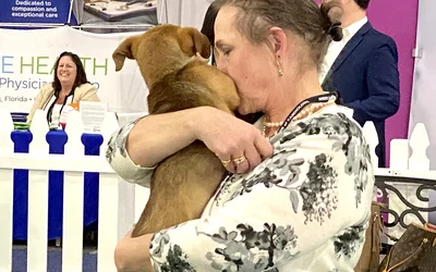 ACC.24 attendees had the chance to hold and pet puppies on the expo floor, sponsored by Boston Scientific.