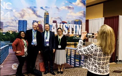 Attendees getting photos in front of the big ASNC 2024 Austin sign. Photo courtesy of ASNC