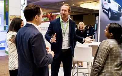 Attendees talk on the expo floor at ASNC 2024. Photo courtesy of ASNC