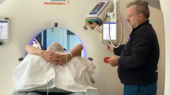Radiology technologists starts an IV for a patient on a CT scanner at Wellstar Kennestone Hospital. Photo by Dave Fornell